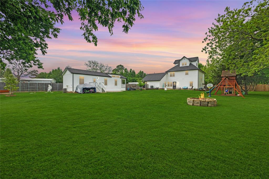 11061 Foutch Road Pilot Point, TX 76258 - Photo 27 of 37 Wide backyard perspective highlights the main home, separate casita, patio space, and generous yard—illustrating the property's flexible living and outdoor potential.