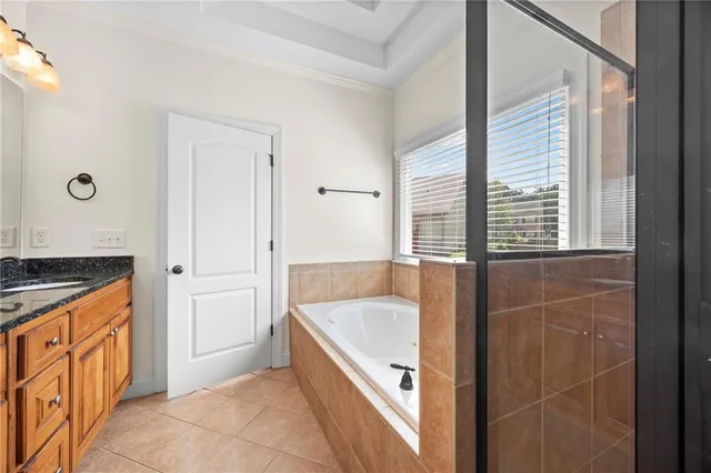 a bathroom with a tub sink and mirror