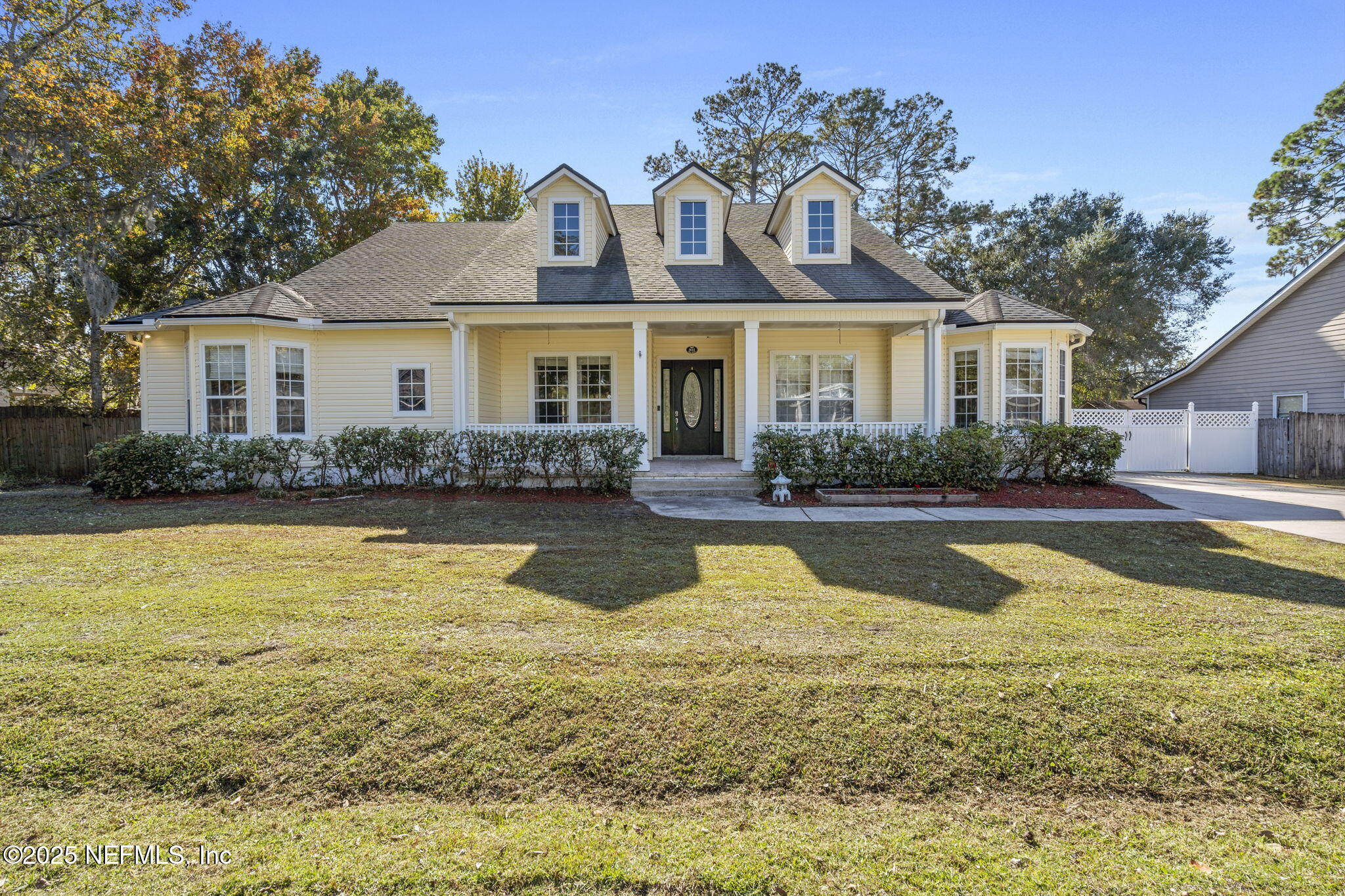 a front view of house with yard and outdoor seating