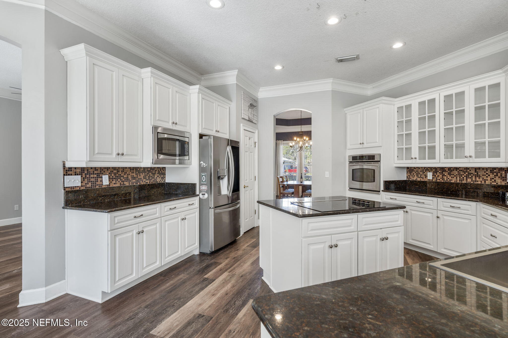 932 Clay Street Fleming Island, FL 32003 - Photo 12 of 50 a kitchen with stainless steel appliances a sink stove refrigerator and cabinets