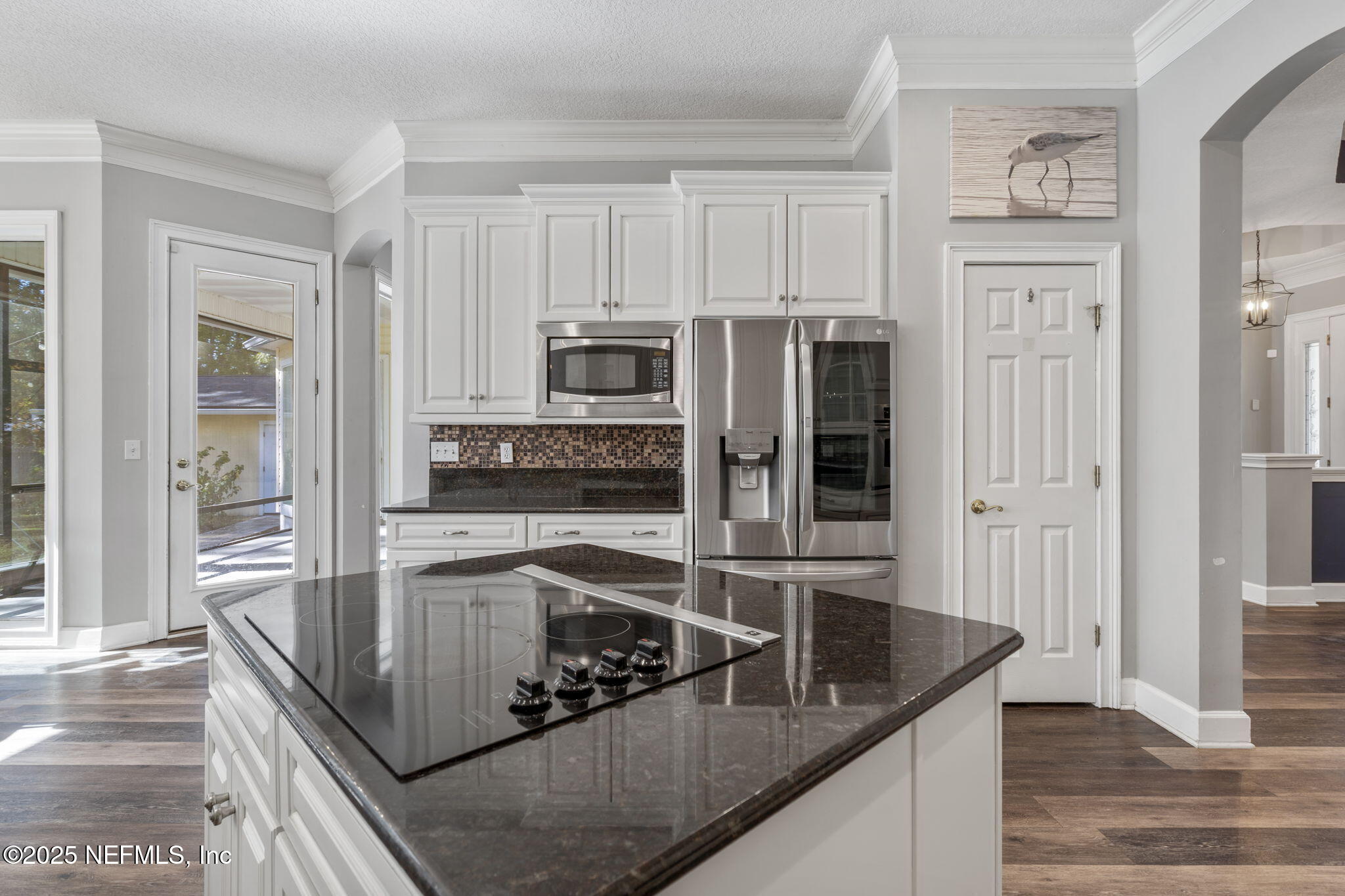 932 Clay Street Fleming Island, FL 32003 - Photo 13 of 50 a kitchen with stainless steel appliances granite countertop a sink a stove and a refrigerator