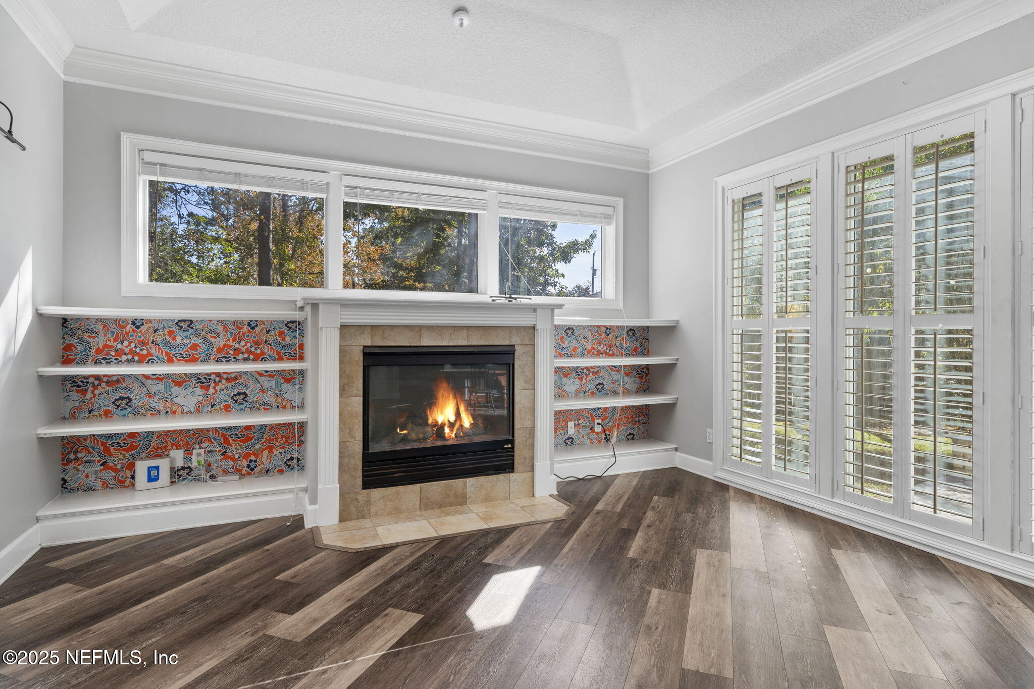 932 Clay Street Fleming Island, FL 32003 - Photo 16 of 50 a living room with a fireplace and a window