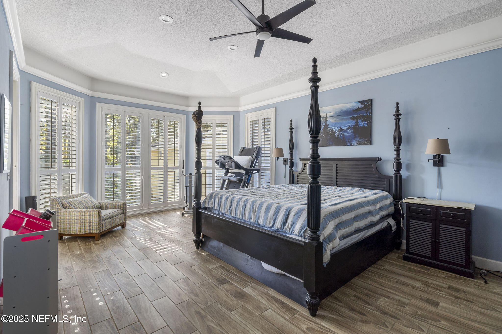 932 Clay Street Fleming Island, FL 32003 - Photo 18 of 50 a bedroom with a bed and wooden floor