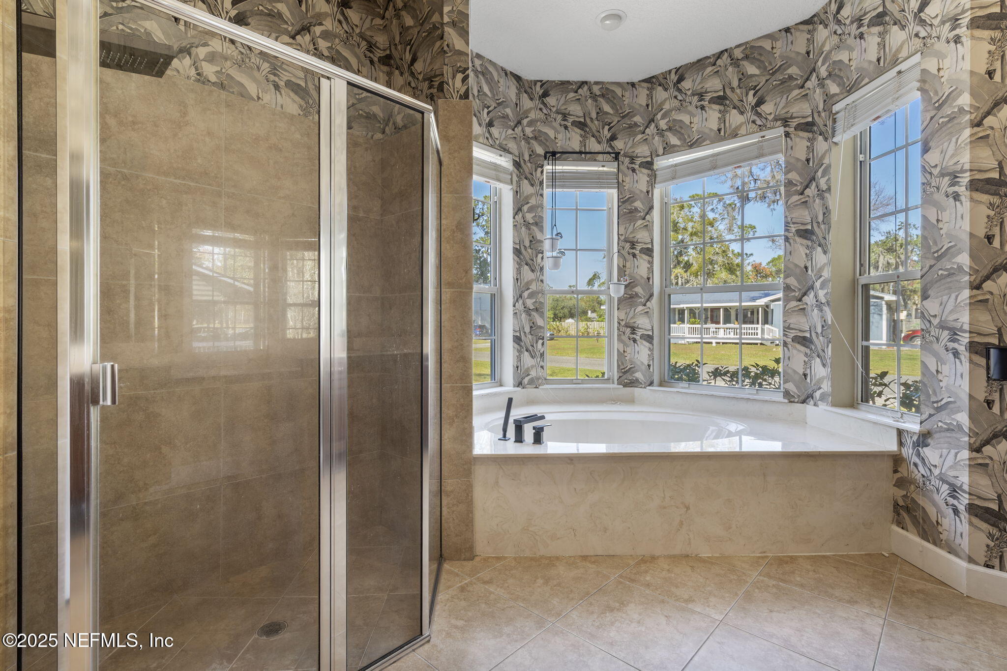 932 Clay Street Fleming Island, FL 32003 - Photo 23 of 50 a bathroom with a bathtub and a shower