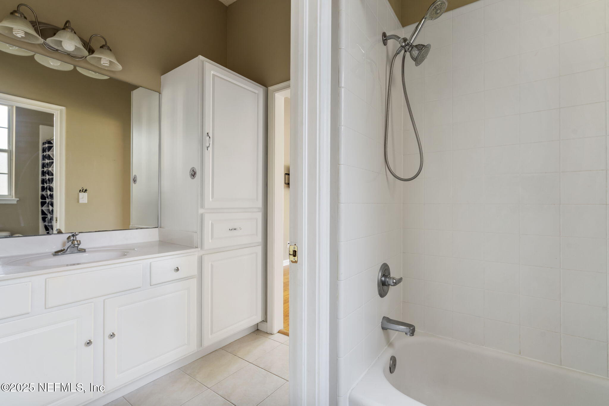 932 Clay Street Fleming Island, FL 32003 - Photo 30 of 50 a bathroom with a granite countertop sink a mirror and a bathtub