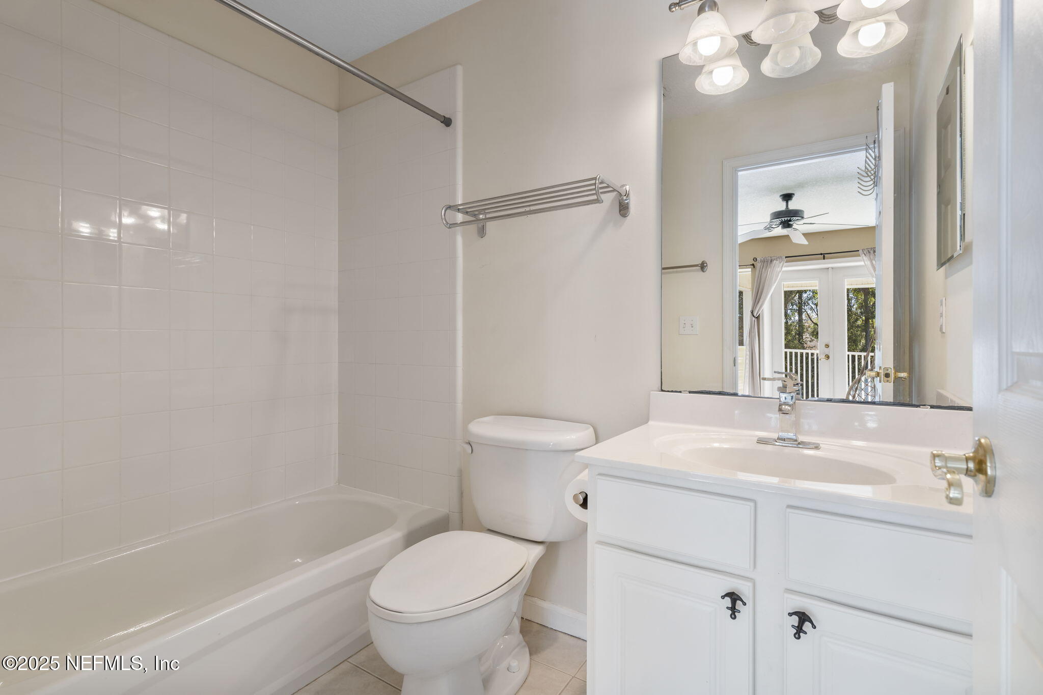 932 Clay Street Fleming Island, FL 32003 - Photo 36 of 50 a bathroom with a sink a toilet and a mirror