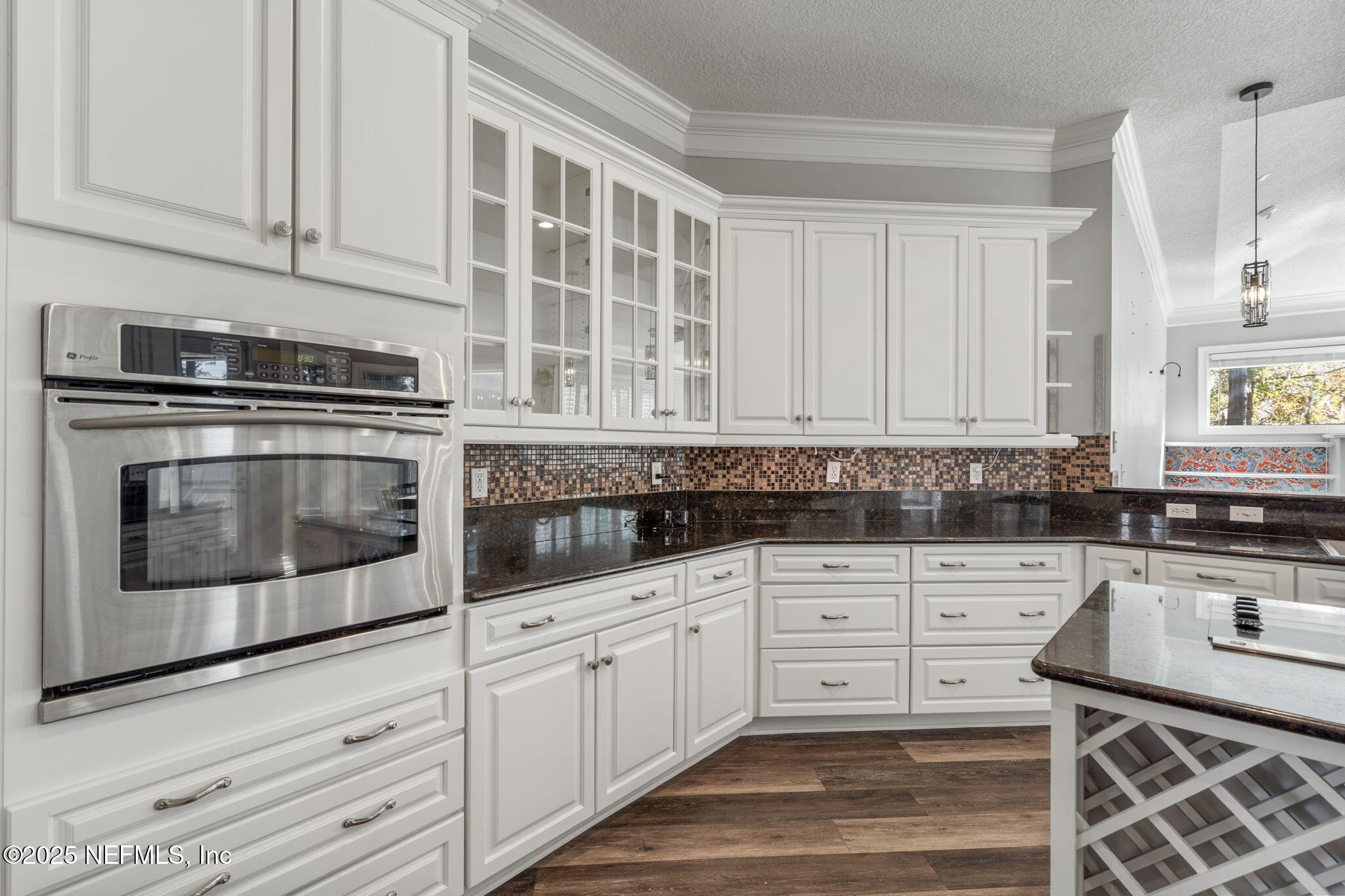 932 Clay Street Fleming Island, FL 32003 - Photo 10 of 50 a kitchen with granite countertop white cabinets stainless steel appliances and a sink