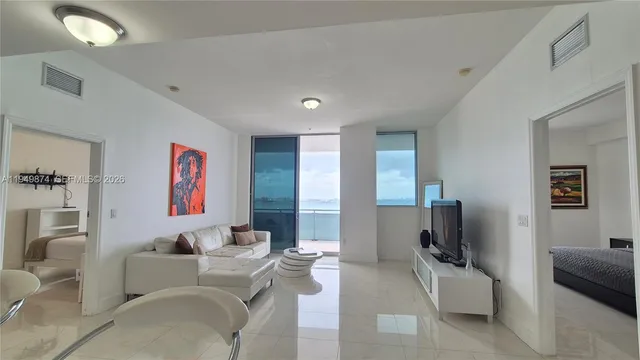 a bedroom with a large bed and a large window