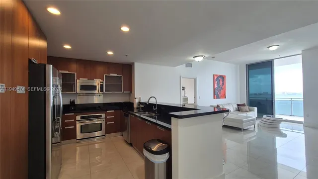 a living room with furniture and kitchen view