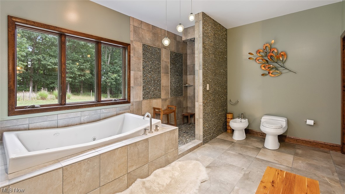 57430 Ohio Riverview Road Shadyside, OH 43947 - Photo 19 of 35 Master bathroom featuring tile walls, shower with separate bathtub, and light tile floors