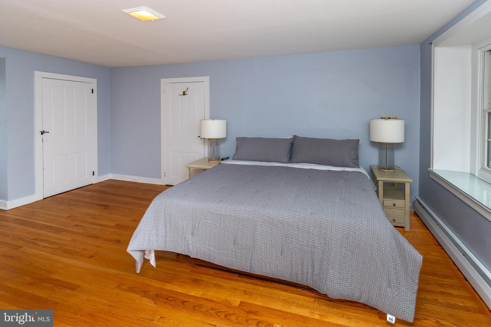 180 Municipal Road Pipersville, PA 18947 - Photo 40 of 60 a bedroom with a bed and a lamp