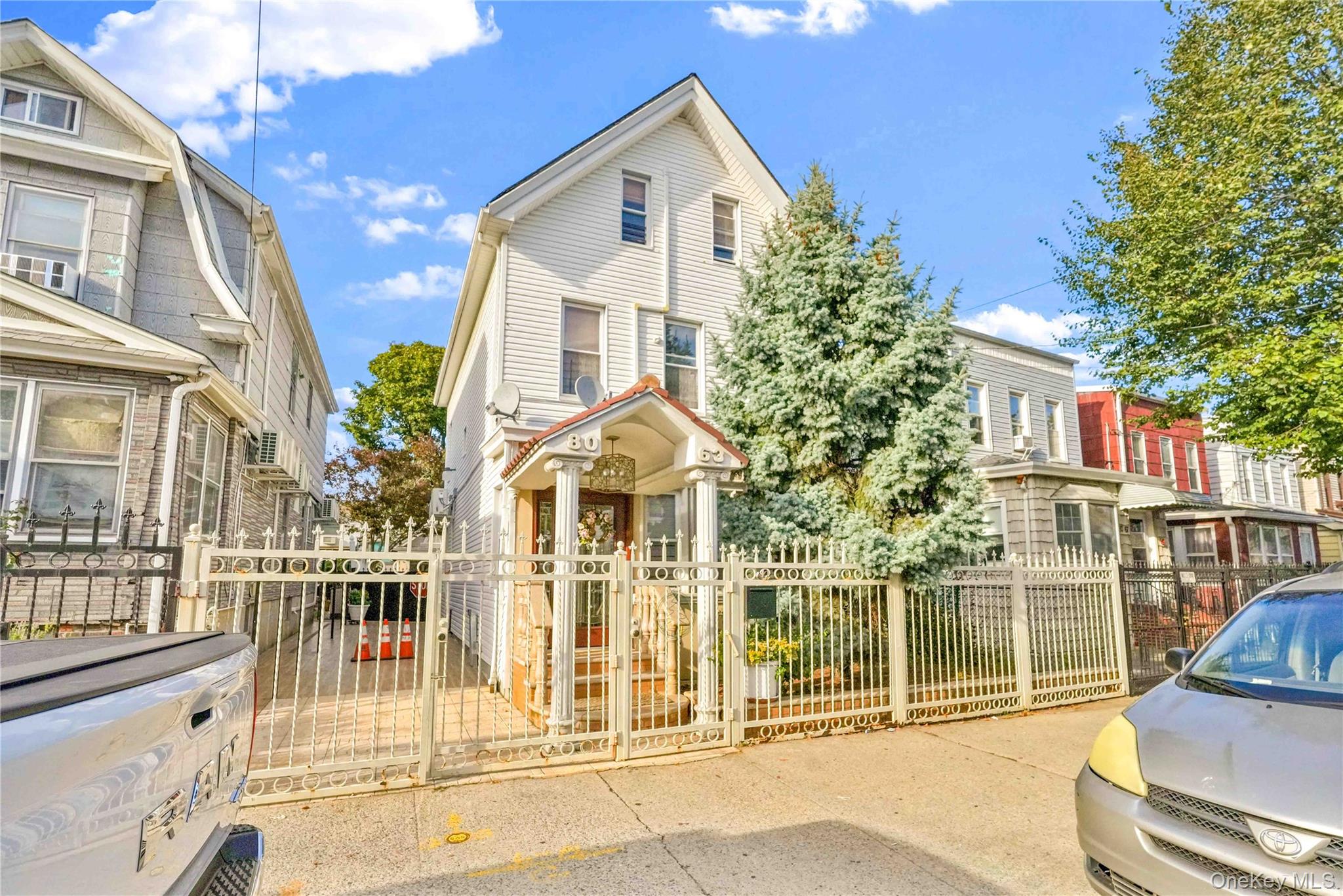 80-63 87th Road Queens, NY 11421 - Photo 1 of 50 View of front of home with a gate, a fenced front yard, and a residential view