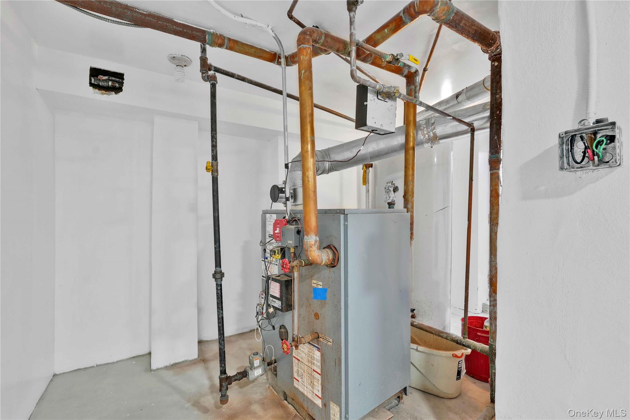80-63 87th Road Queens, NY 11421 - Photo 12 of 50 Utilities with a heating unit, natural gas.