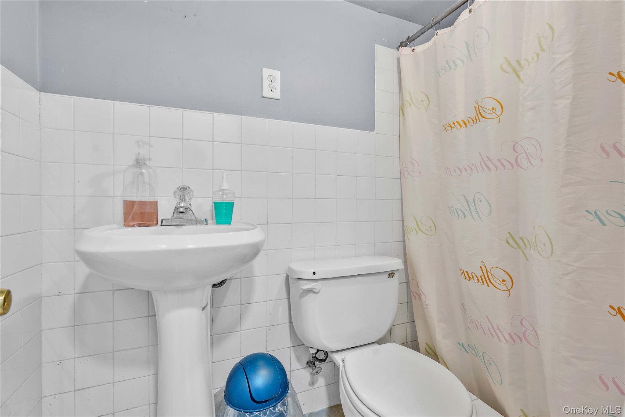 80-63 87th Road Queens, NY 11421 - Photo 15 of 50 Full basement bathroom with tile walls and a wainscoted wall
