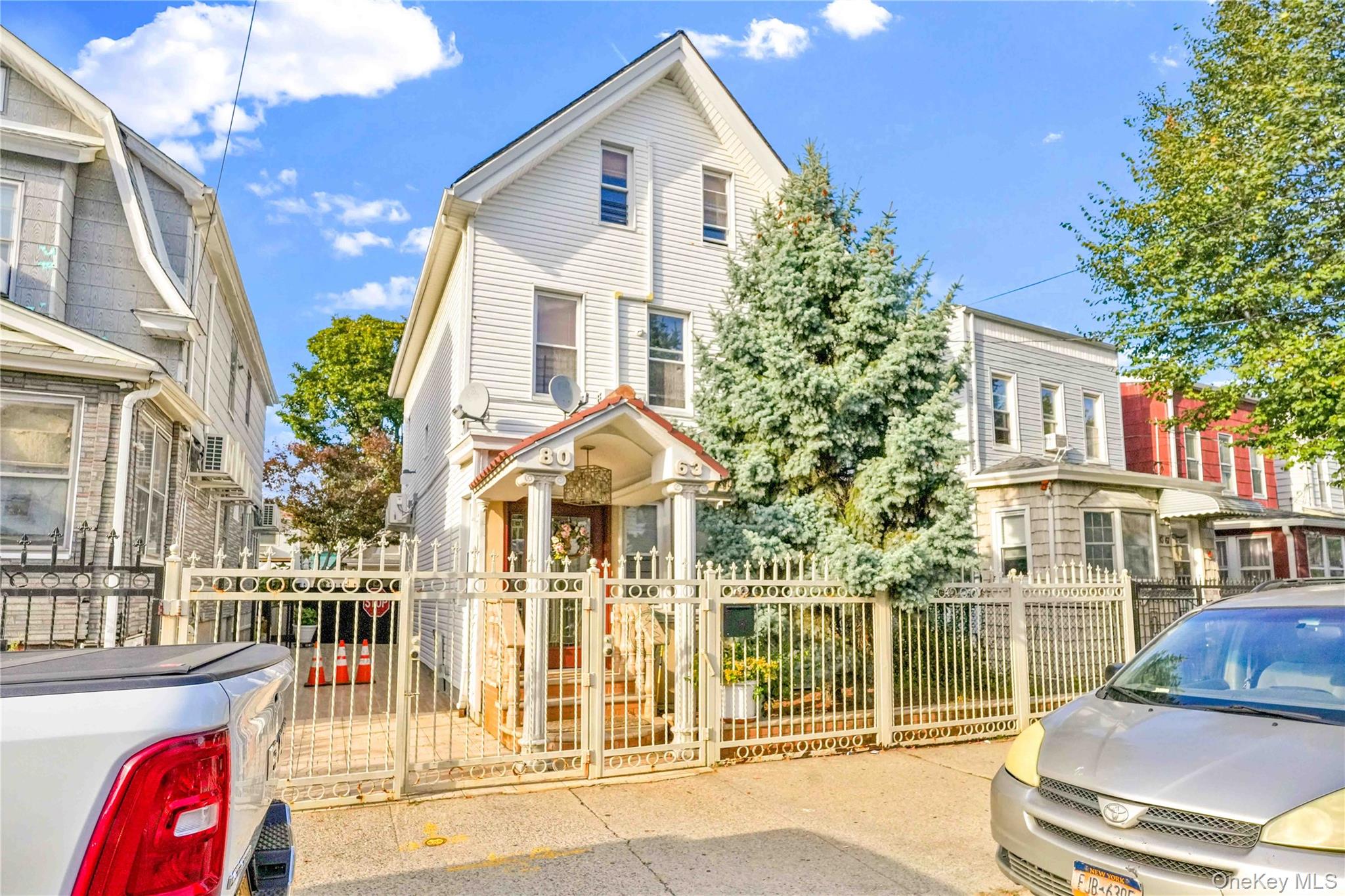 80-63 87th Road Queens, NY 11421 - Photo 2 of 50 View of front of property featuring a gate and a fenced front yard