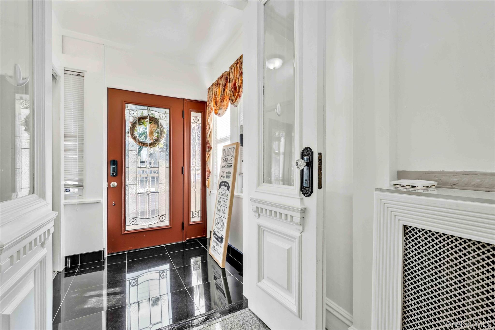 80-63 87th Road Queens, NY 11421 - Photo 27 of 50 Entrance foyer featuring granite floors and radiator