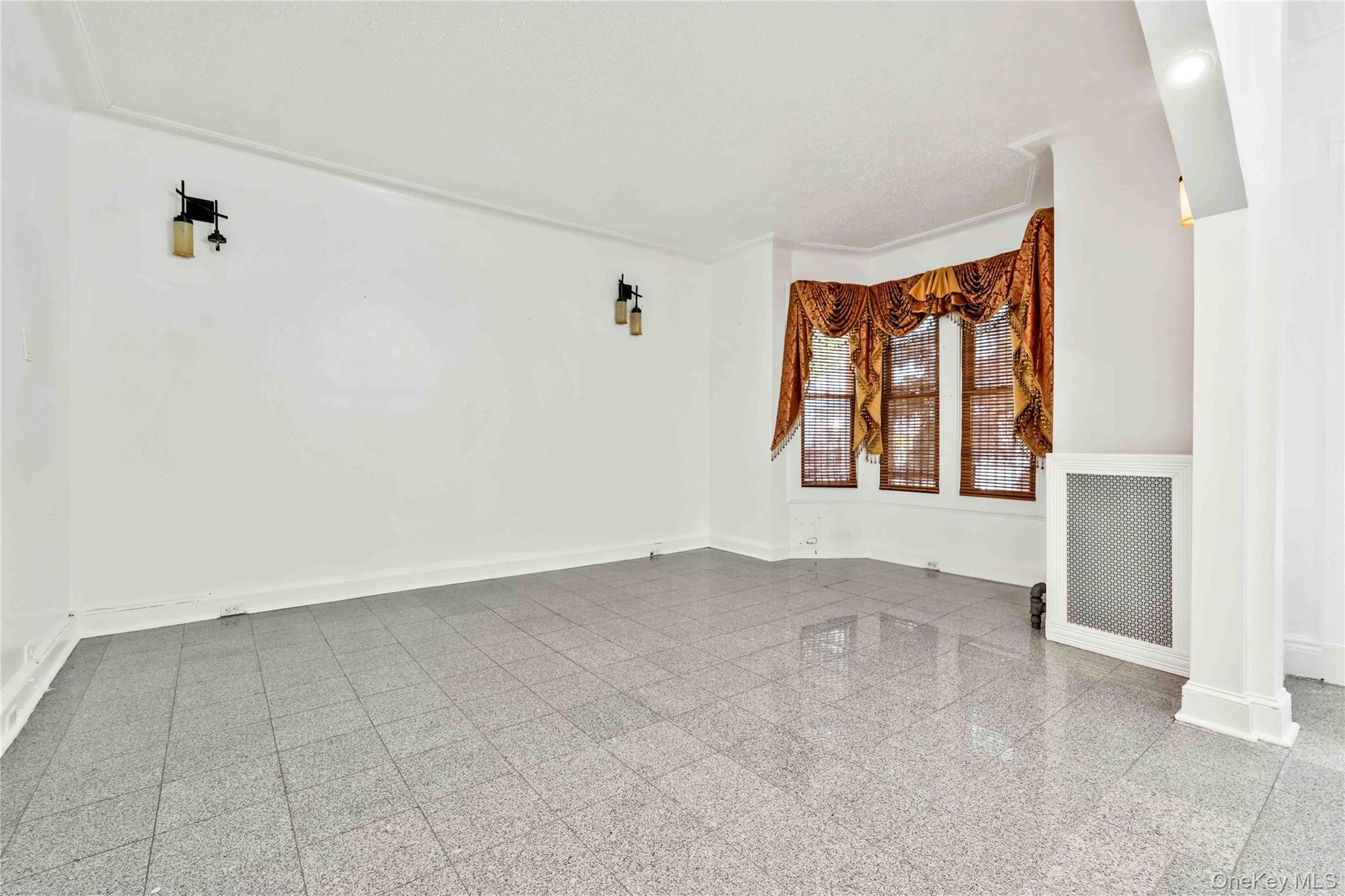 80-63 87th Road Queens, NY 11421 - Photo 29 of 50 livingroom with baseboards and granite tiled floors
