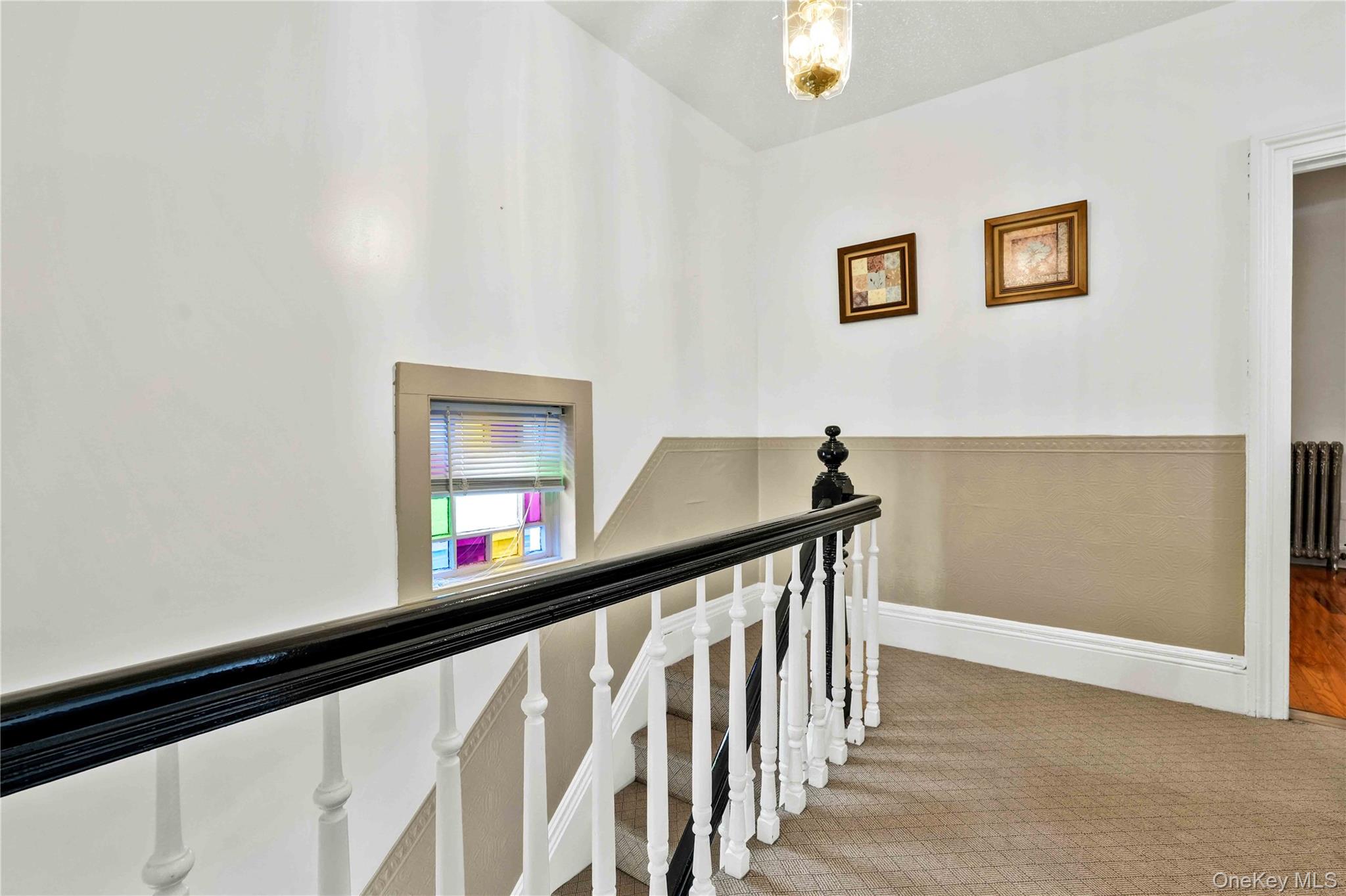 80-63 87th Road Queens, NY 11421 - Photo 36 of 50 Staircase with carpet flooring and radiator