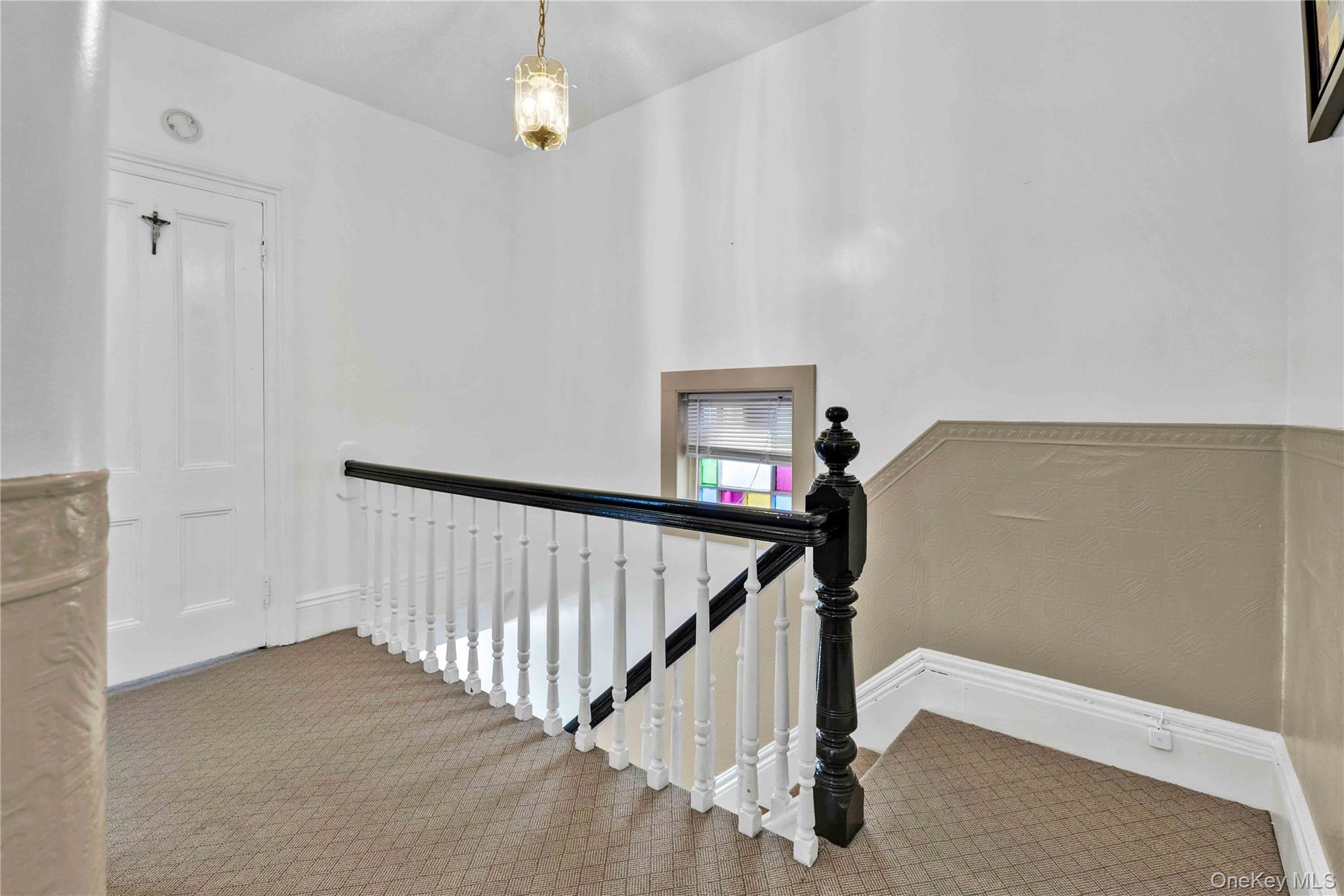 80-63 87th Road Queens, NY 11421 - Photo 37 of 50 Staircase with carpet and baseboards