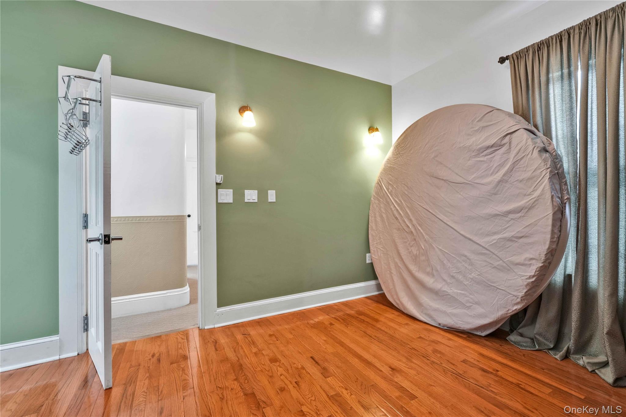 80-63 87th Road Queens, NY 11421 - Photo 39 of 50 Bedroom featuring light wood finished floors and baseboards