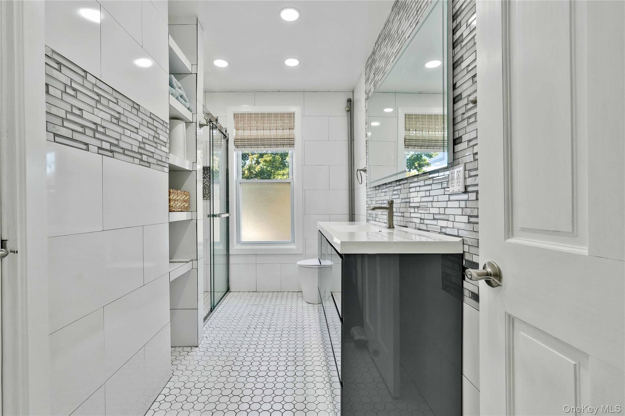 80-63 87th Road Queens, NY 11421 - Photo 41 of 50 Full main bath with tile walls, vanity, a shower stall, recessed lighting, and light tile patterned floors