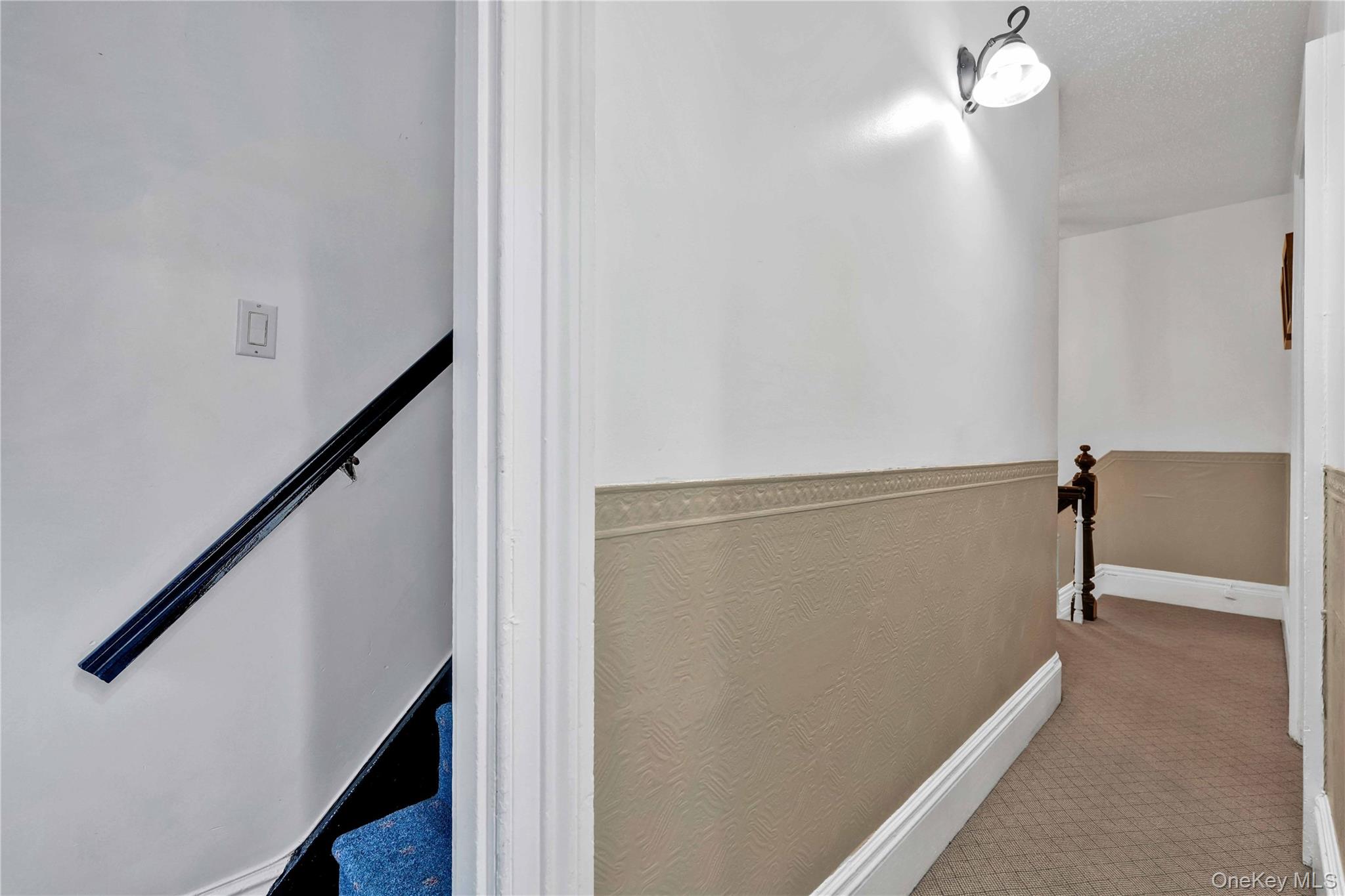 80-63 87th Road Queens, NY 11421 - Photo 42 of 50 Hall with carpet, a textured ceiling, and a wainscoted wall