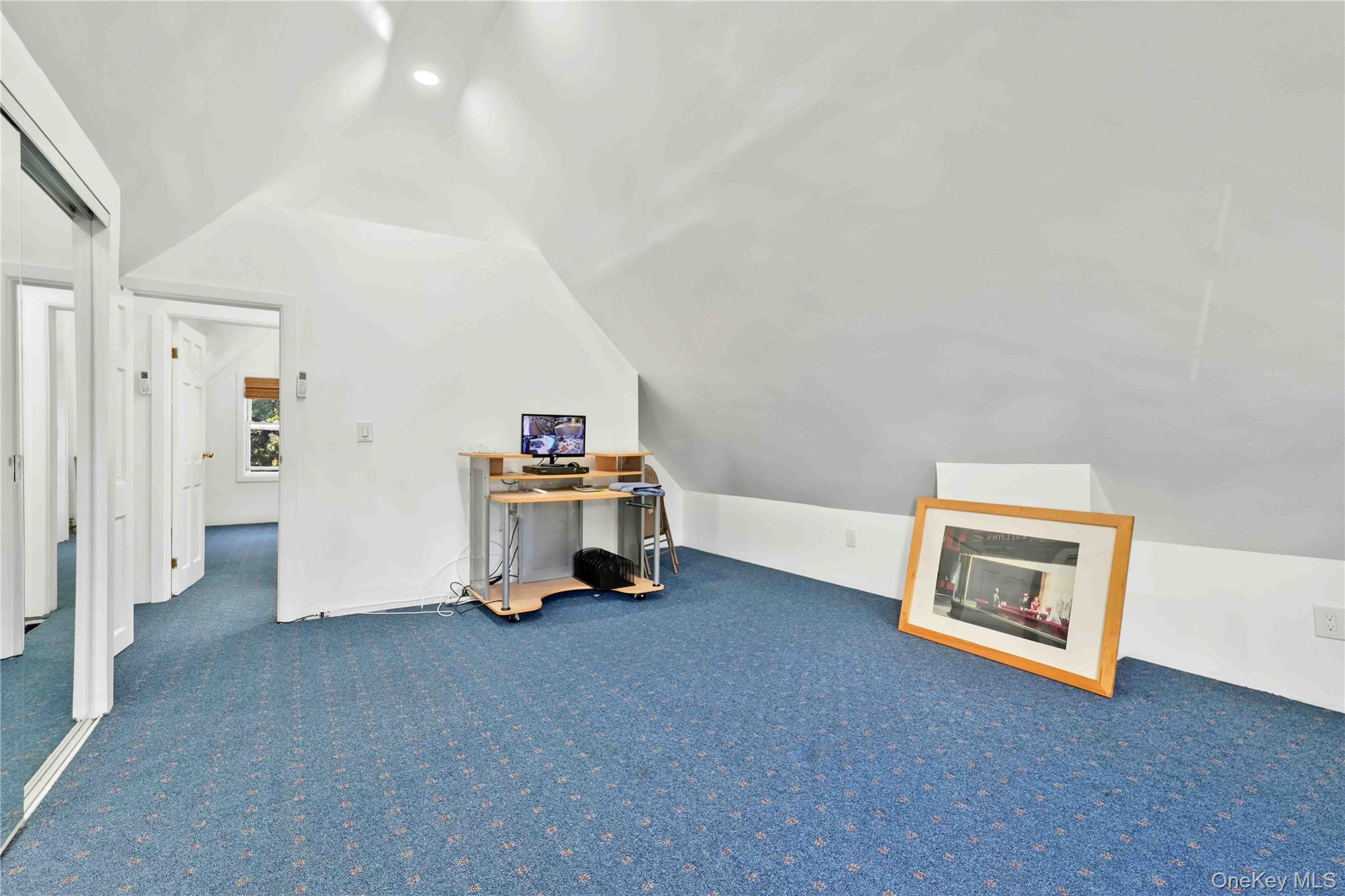 80-63 87th Road Queens, NY 11421 - Photo 44 of 50 Additional bedroom living space with lofted ceiling and carpet