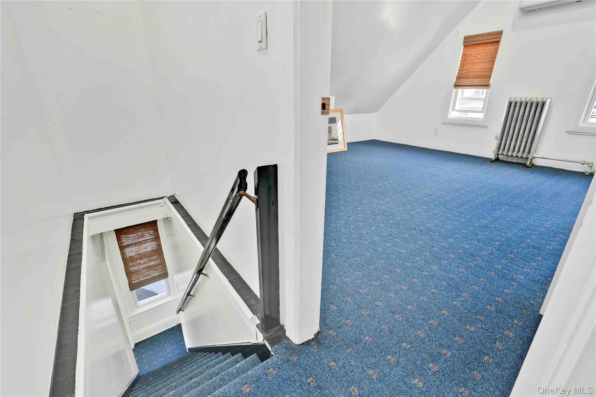 80-63 87th Road Queens, NY 11421 - Photo 46 of 50 Bonus bedroom featuring carpet flooring, vaulted ceiling, radiator, and an AC wall unit