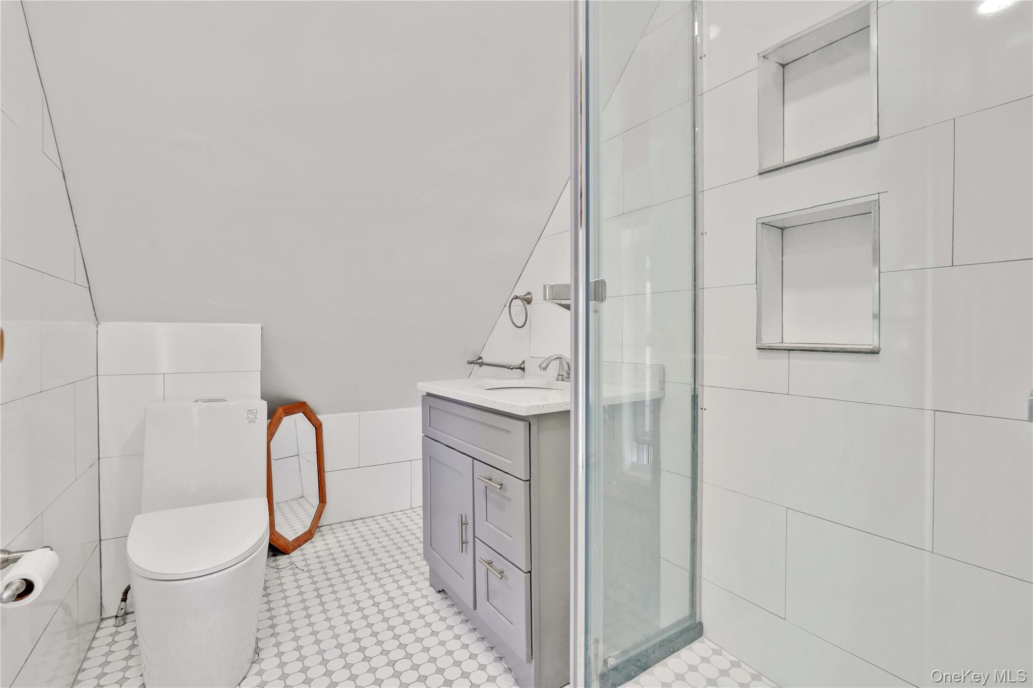 80-63 87th Road Queens, NY 11421 - Photo 48 of 50 third floor Bathroom with vanity, a shower stall, and tile walls