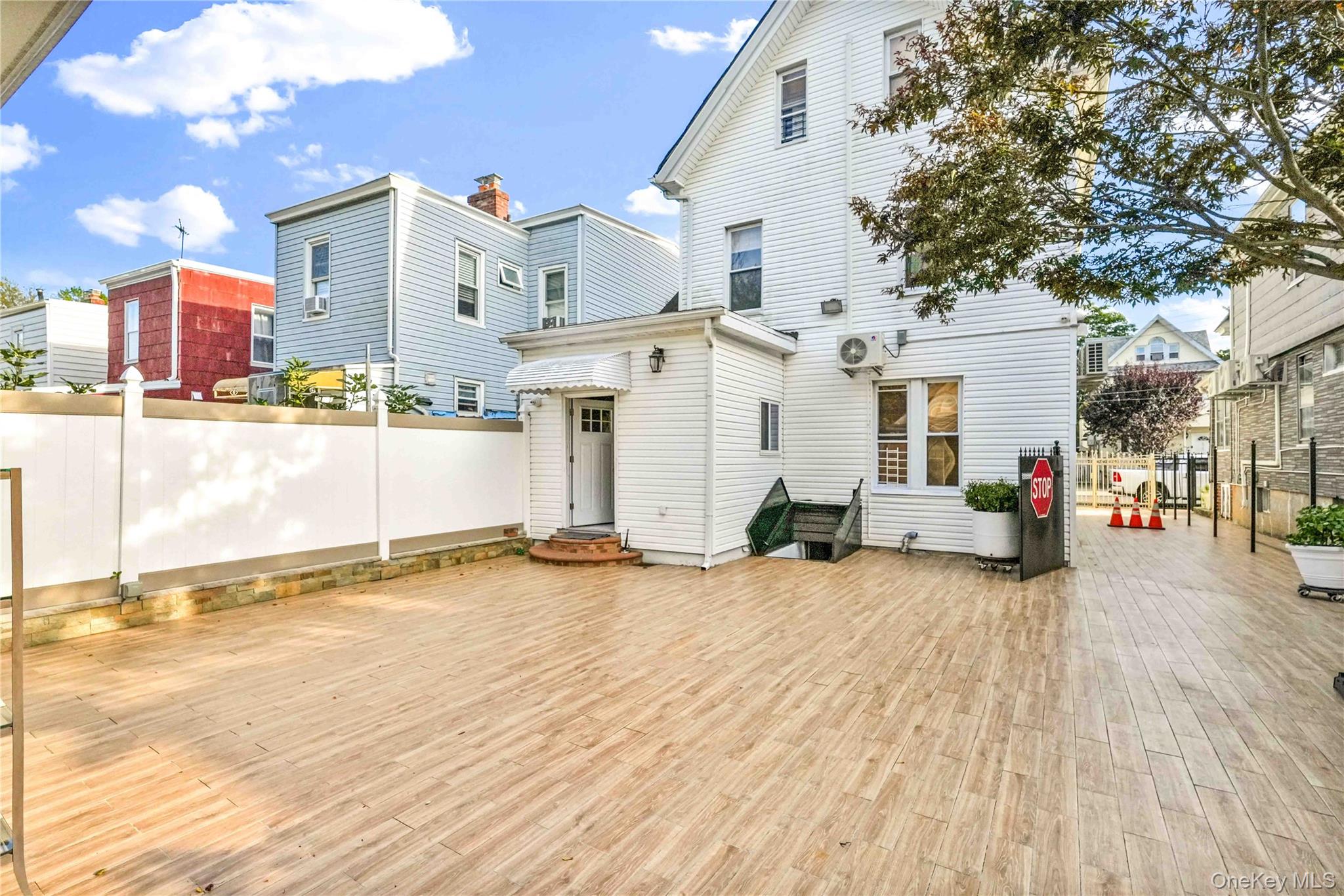 80-63 87th Road Queens, NY 11421 - Photo 8 of 50 Back of property with entry steps and a patio