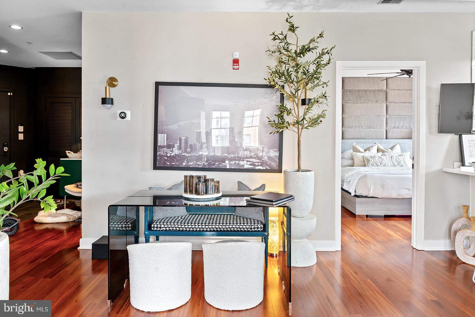 181 East Reed Avenue, Unit 207 Alexandria, VA 22305 - Photo 15 of 41 a living room with furniture a potted plant and a wooden floor
