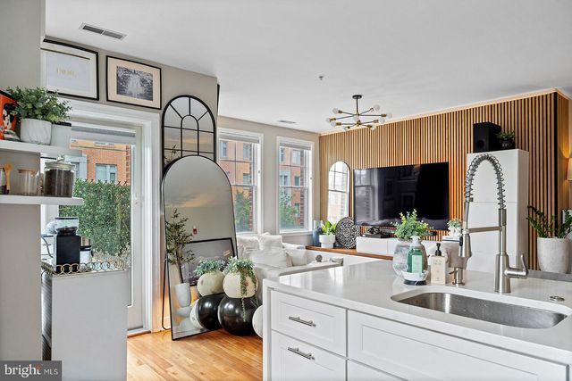 a kitchen with refrigerator cabinets and wooden floor