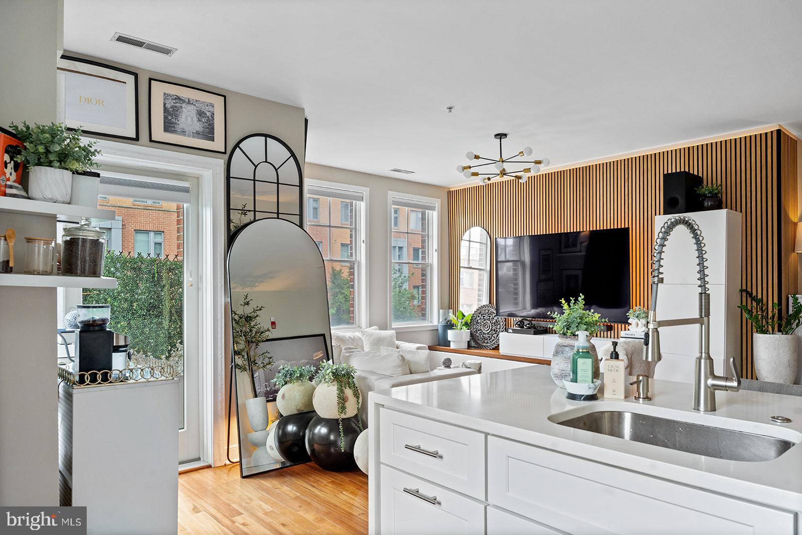 181 East Reed Avenue, Unit 207 Alexandria, VA 22305 - Photo 16 of 41 a living room with furniture a large window and a flat screen tv