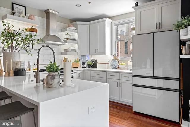 a kitchen with stainless steel appliances granite countertop a sink stove and cabinets