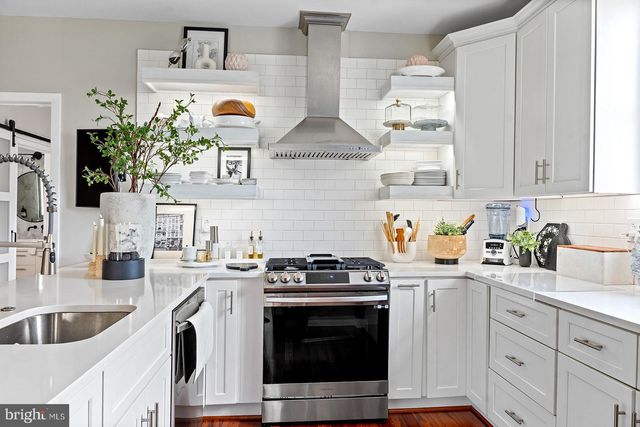 a stove top oven sitting inside of a kitchen