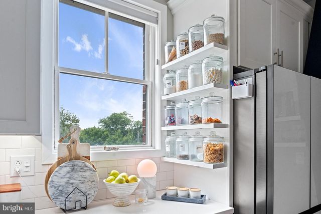 a stove top oven sitting inside of a kitchen