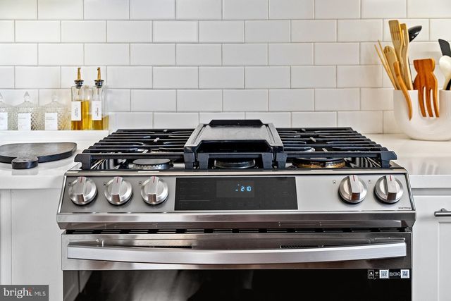a stove top oven sitting inside of a kitchen