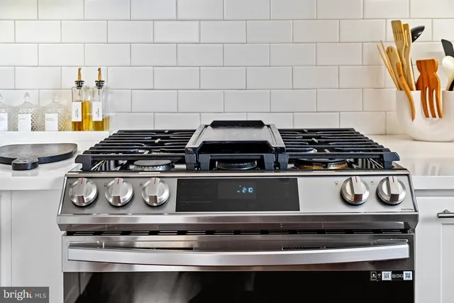 a stove top oven sitting inside of a kitchen