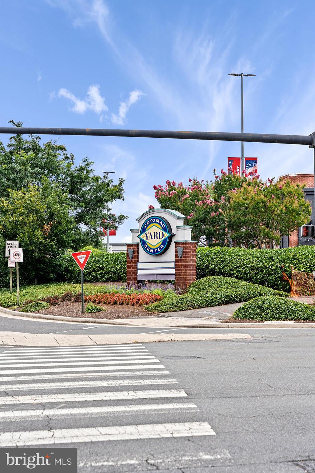 181 East Reed Avenue, Unit 207 Alexandria, VA 22305 - Photo 2 of 41 a front view of a house with a yard and potted plants