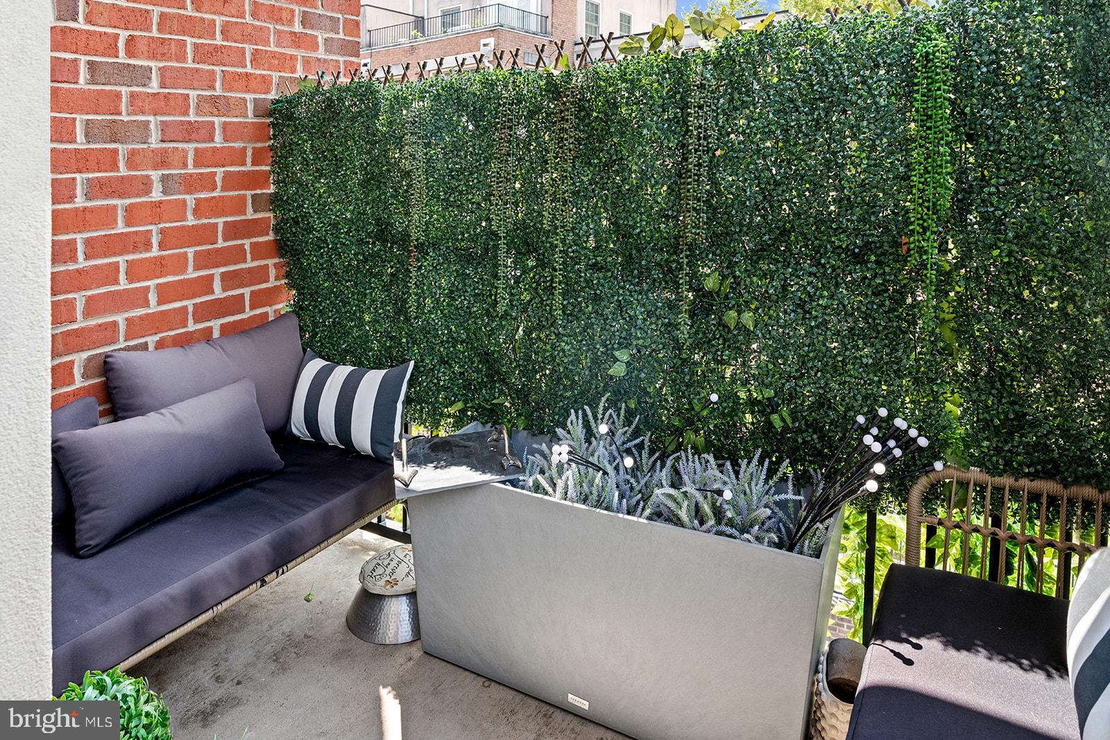181 East Reed Avenue, Unit 207 Alexandria, VA 22305 - Photo 25 of 41 a balcony with couch and a potted plant