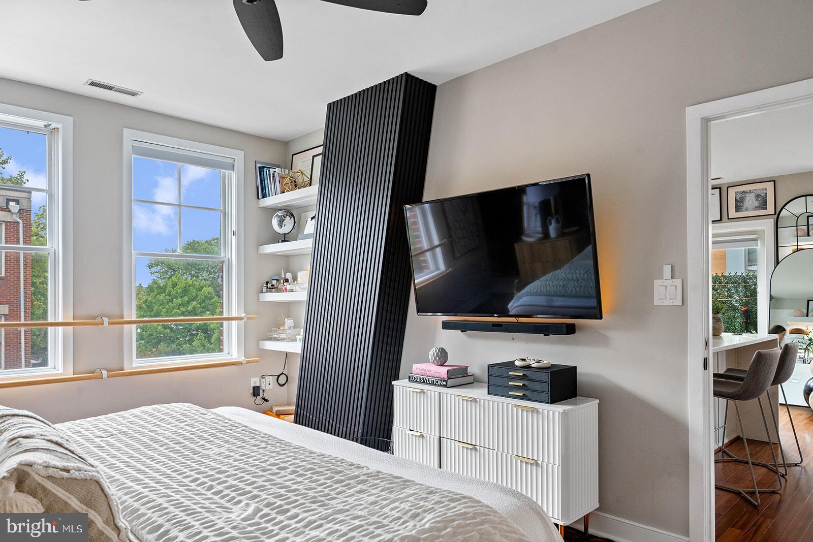 181 East Reed Avenue, Unit 207 Alexandria, VA 22305 - Photo 28 of 41 a bedroom with a bed and a flat screen tv