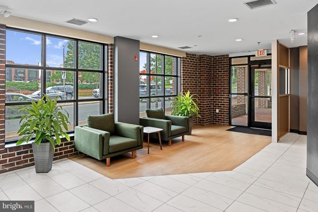 a living room with furniture and large windows