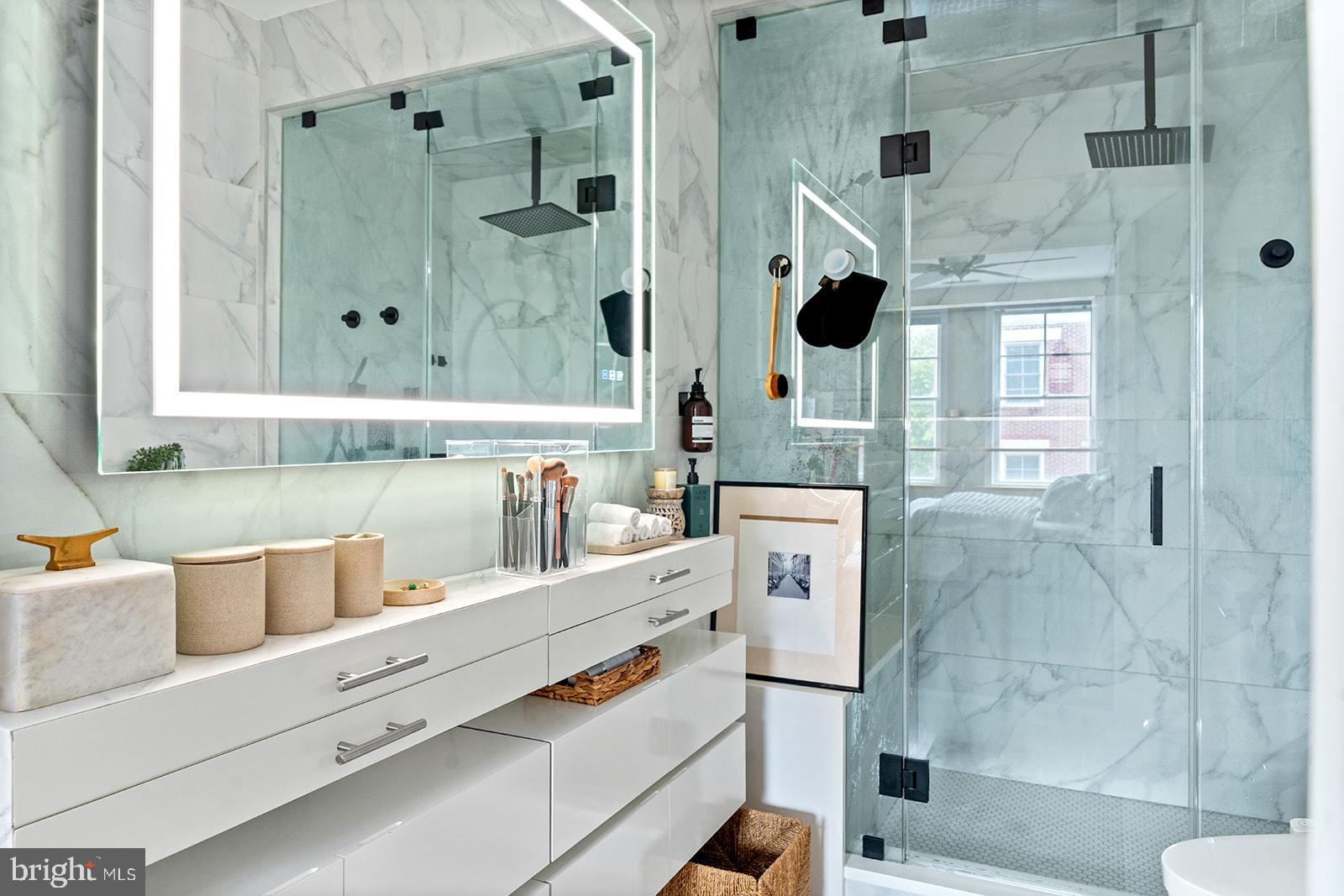 181 East Reed Avenue, Unit 207 Alexandria, VA 22305 - Photo 31 of 41 a bathroom with a shower sink and mirror