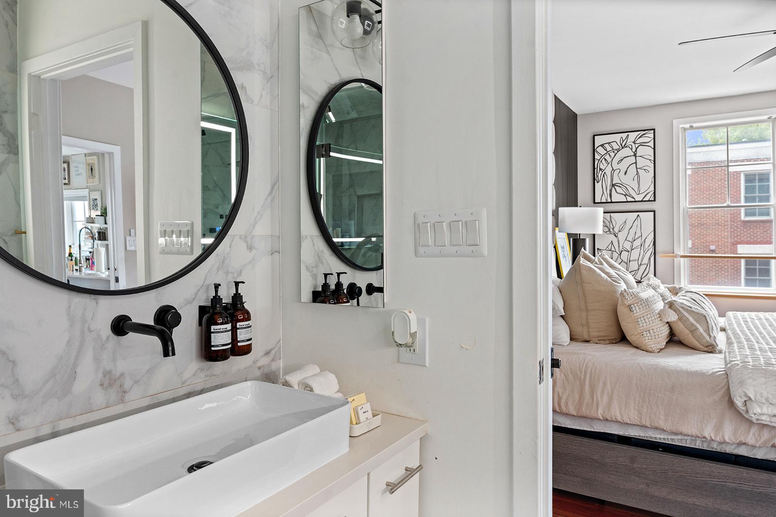 181 East Reed Avenue, Unit 207 Alexandria, VA 22305 - Photo 33 of 41 a living room with furniture and a mirror