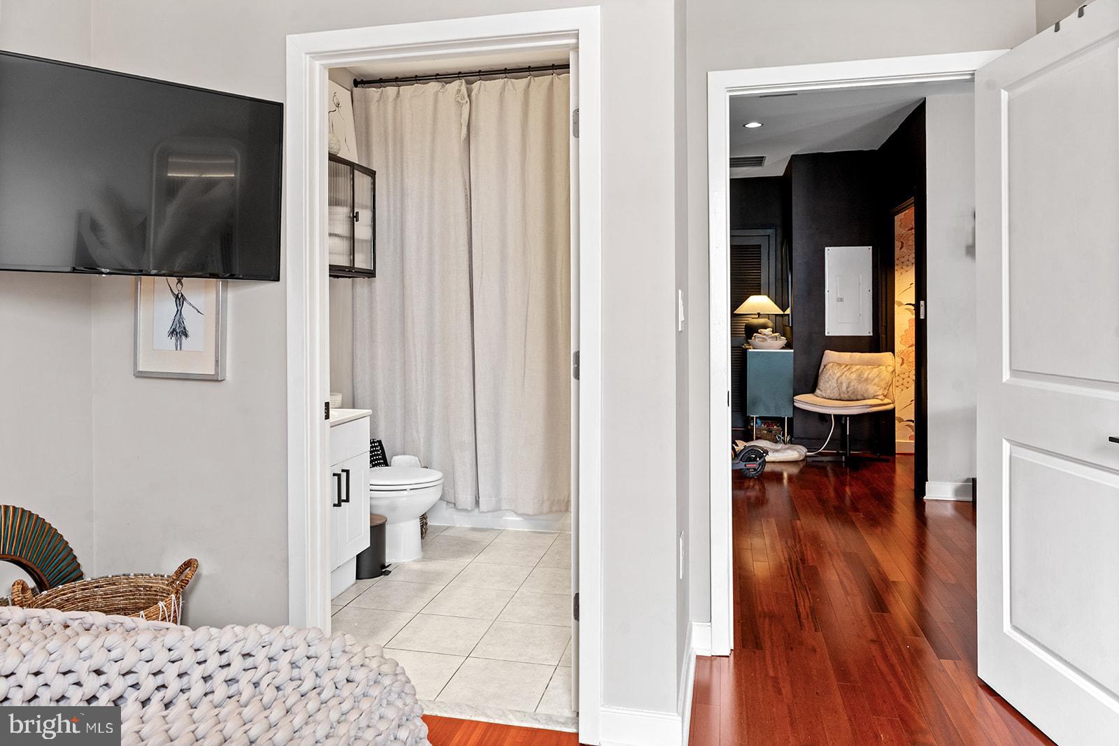 181 East Reed Avenue, Unit 207 Alexandria, VA 22305 - Photo 37 of 41 a living room with furniture and a flat screen tv