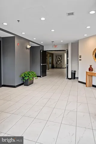 a view of a hallway with wooden floor