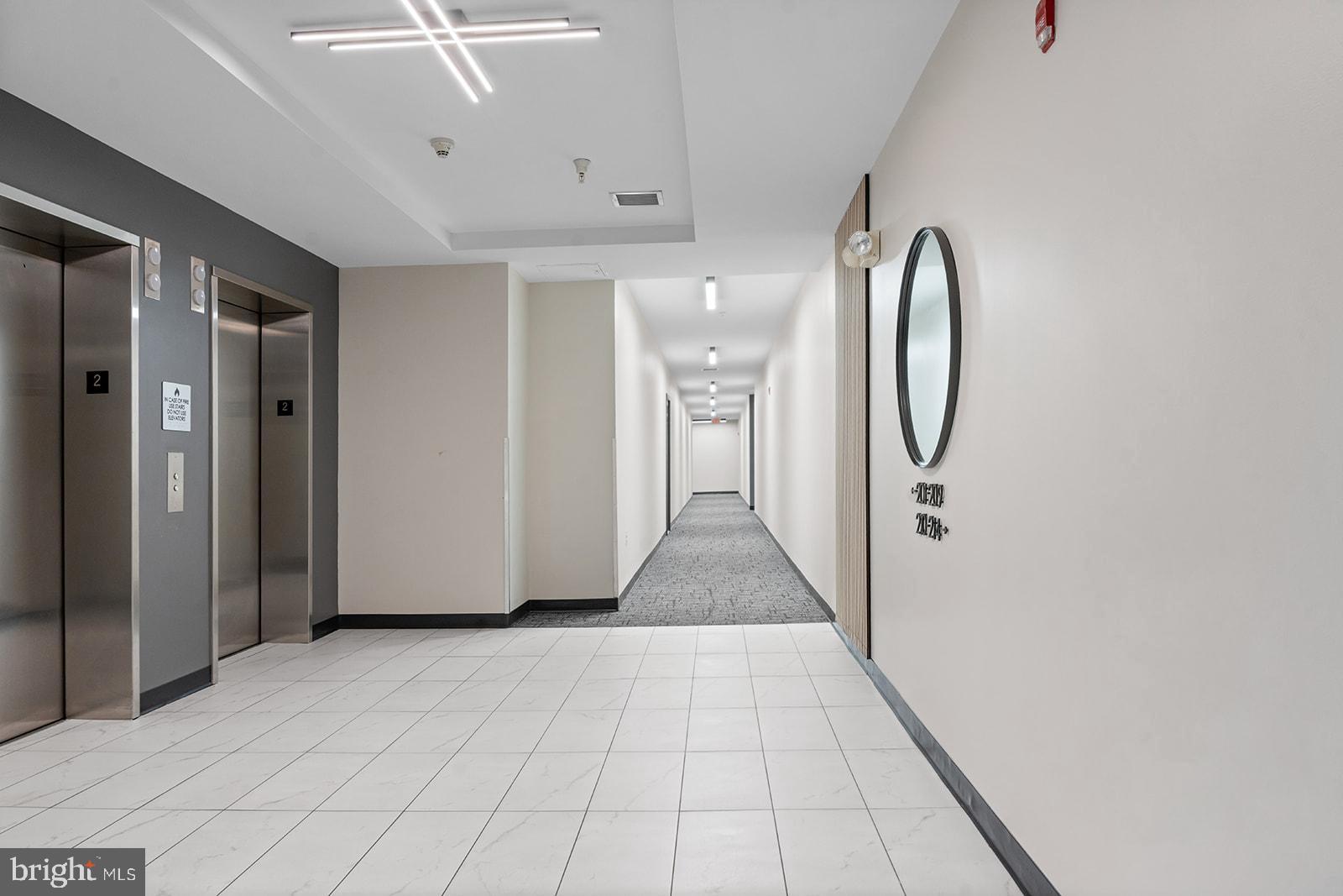 181 East Reed Avenue, Unit 207 Alexandria, VA 22305 - Photo 7 of 41 a view of a hallway with wooden floor