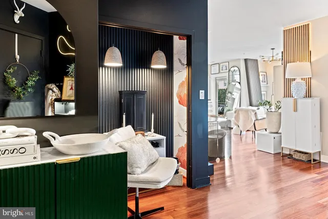 a living room with furniture and a dining table with kitchen view