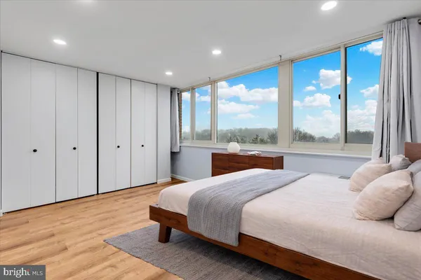 a bedroom with a large bed and a large window