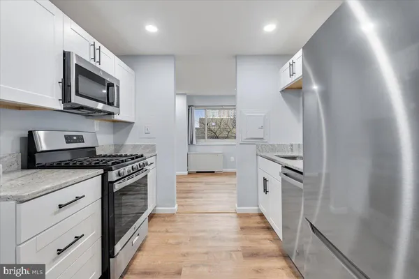 a kitchen with stainless steel appliances granite countertop a stove and a sink